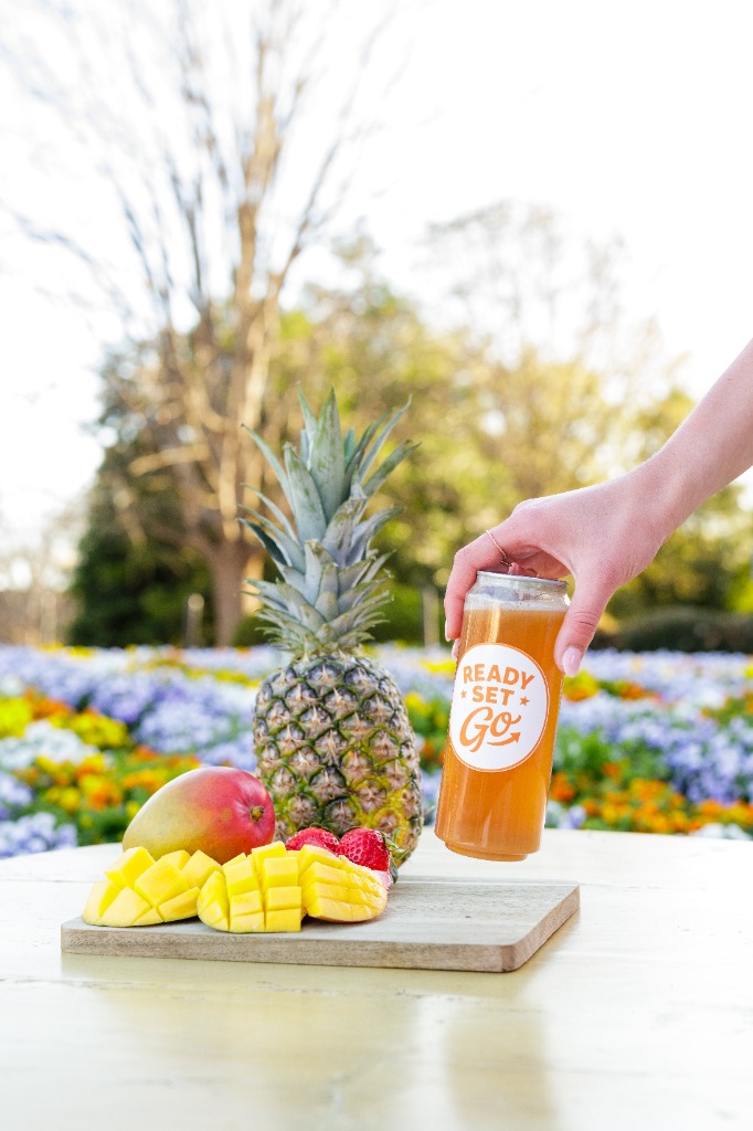 Ready SET Go tea held up with tropical fruits